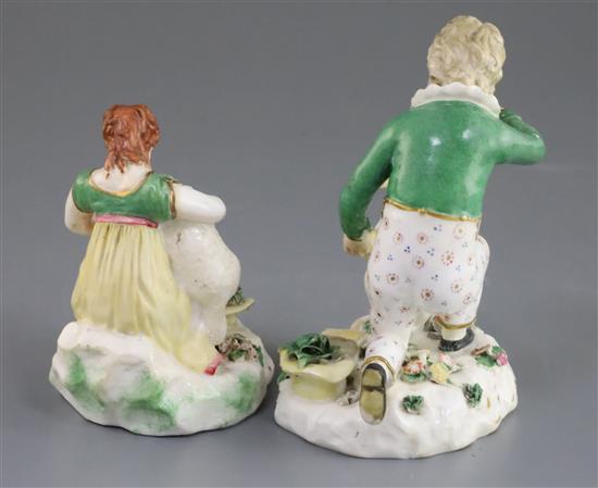 A pair of Rockingham porcelain groups of a boy feeding a rabbit and a girl seated with a lamb, c.1830, h. 14cm and 10.5cm, some faults